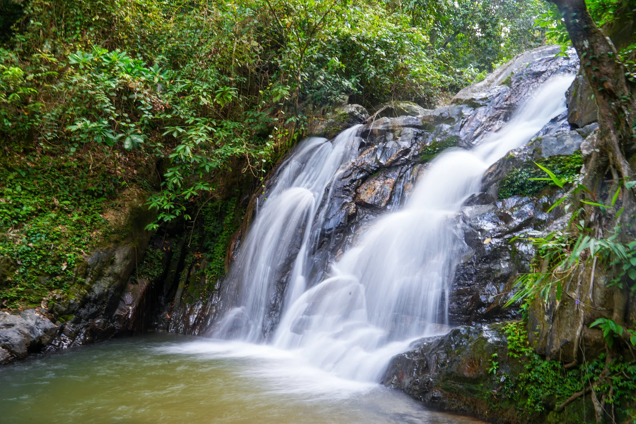 Jungle waterfall cascading over boulders at the end of the rainforest trek near Khao Lak