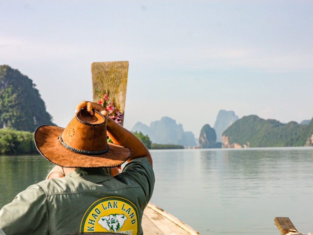 A Khao Lak Land Discovery guide on a longtail boat in Phang Nga Bay