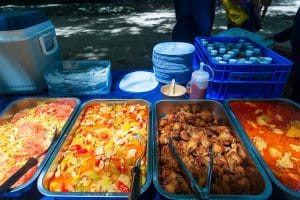 Thai buffet picnic lunch with curries, salad and fried chicken served on the beach, Similan Islands tour