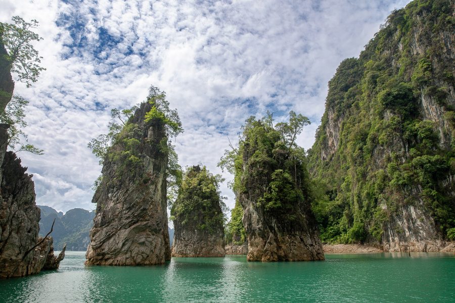 Limestone karst pillars rising from the emerald water of Cheow Lan Lake, Khao Sok National Park