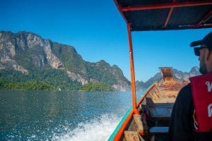 View from a longtail boat speeding across Cheow Lan Lake toward limestone mountains, Khao Sok