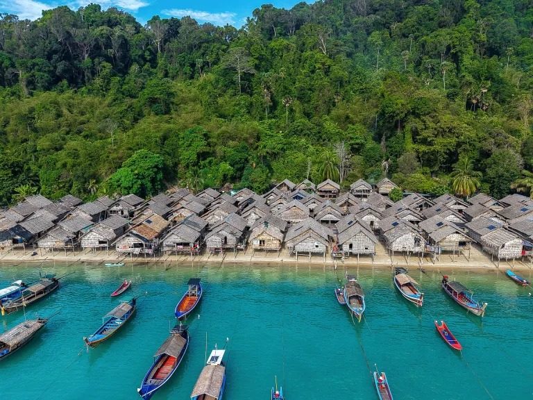 Aerial view of the Moken sea-gypsy village and longtail boats in turquoise water, Surin Islands, Thailand