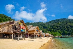 Thatched stilt houses of the Moken village along a sandy beach on the Surin Islands, Phang Nga