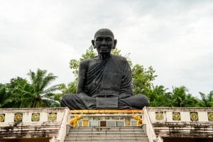 Giant black statue of a revered seated monk at Wat Manee Sri Mahathat, Phang Nga