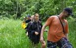 Hikers trekking a dense jungle trail in Khao Sok