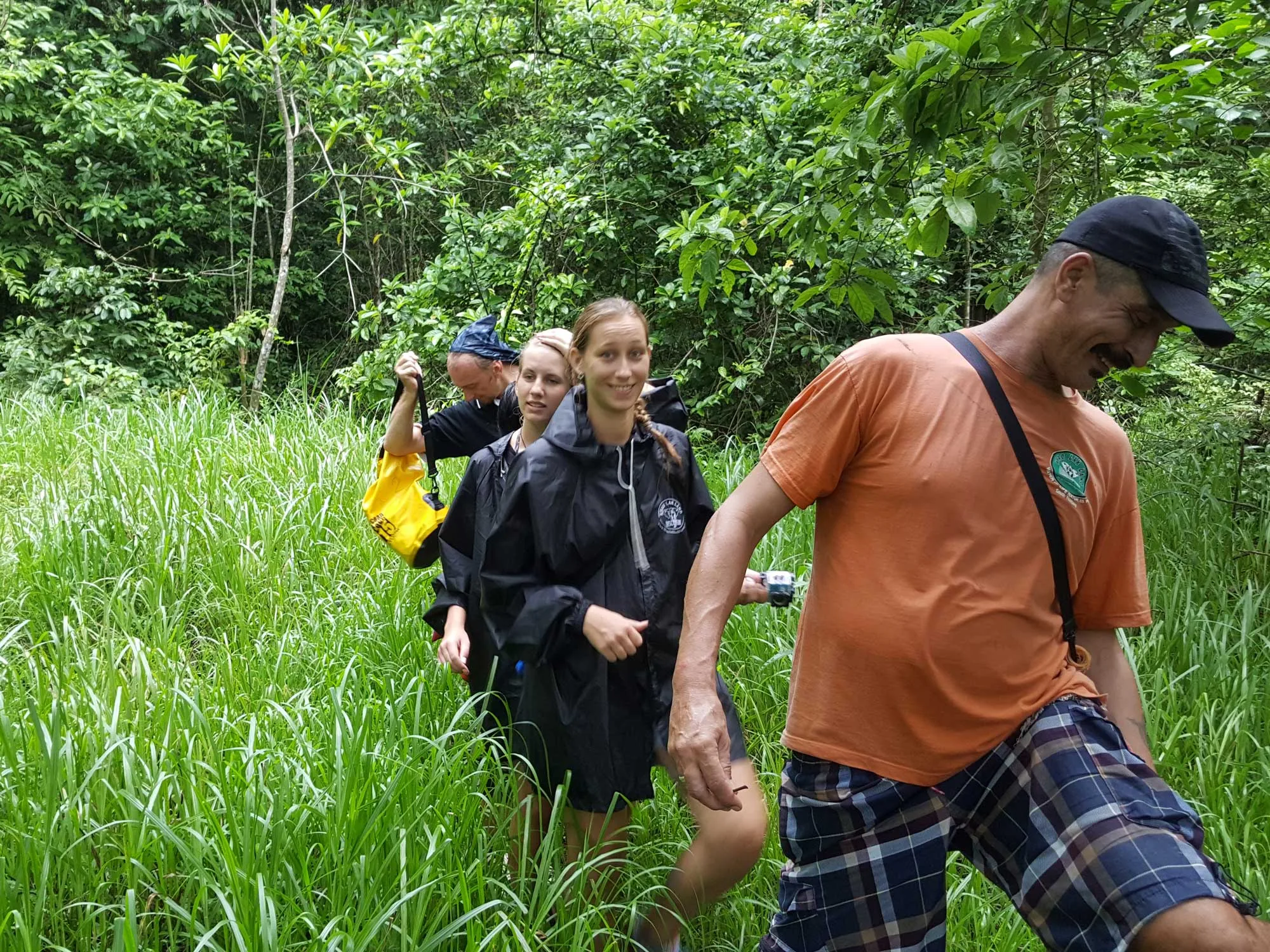 Hikers trekking a dense jungle trail in Khao Sok
