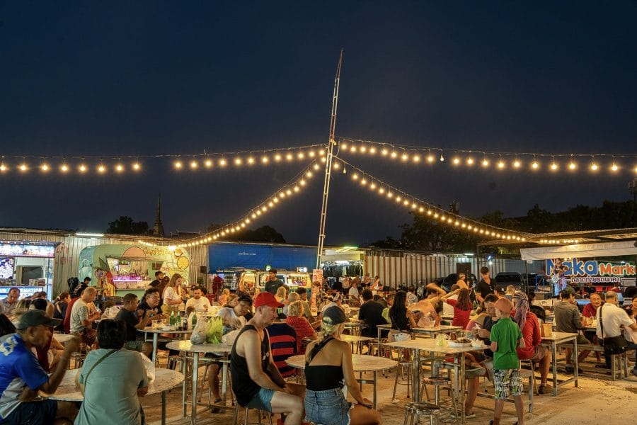 Naka Weekend Market food court under strings of festoon lights at night, Phuket