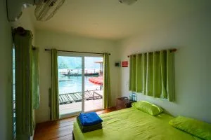 Inside a floating bungalow on Cheow Lan Lake: double bed and sliding doors opening onto the lake