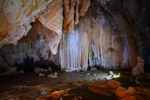 Glittering stalactites and flowstone inside a limestone cave explored on the Cheow Lan Lake trek