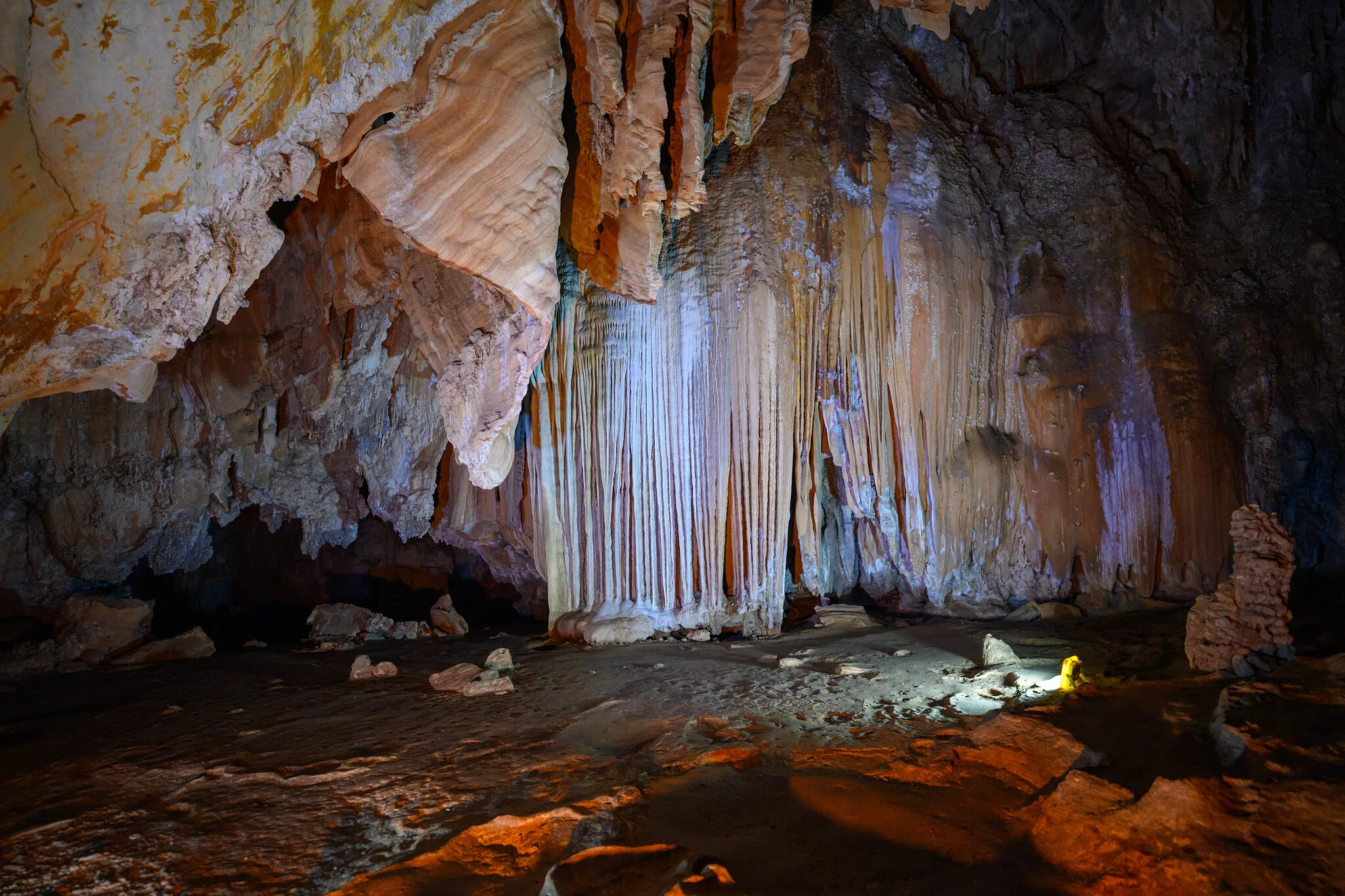 Glittering stalactites and flowstone inside a limestone cave explored on the Cheow Lan Lake trek