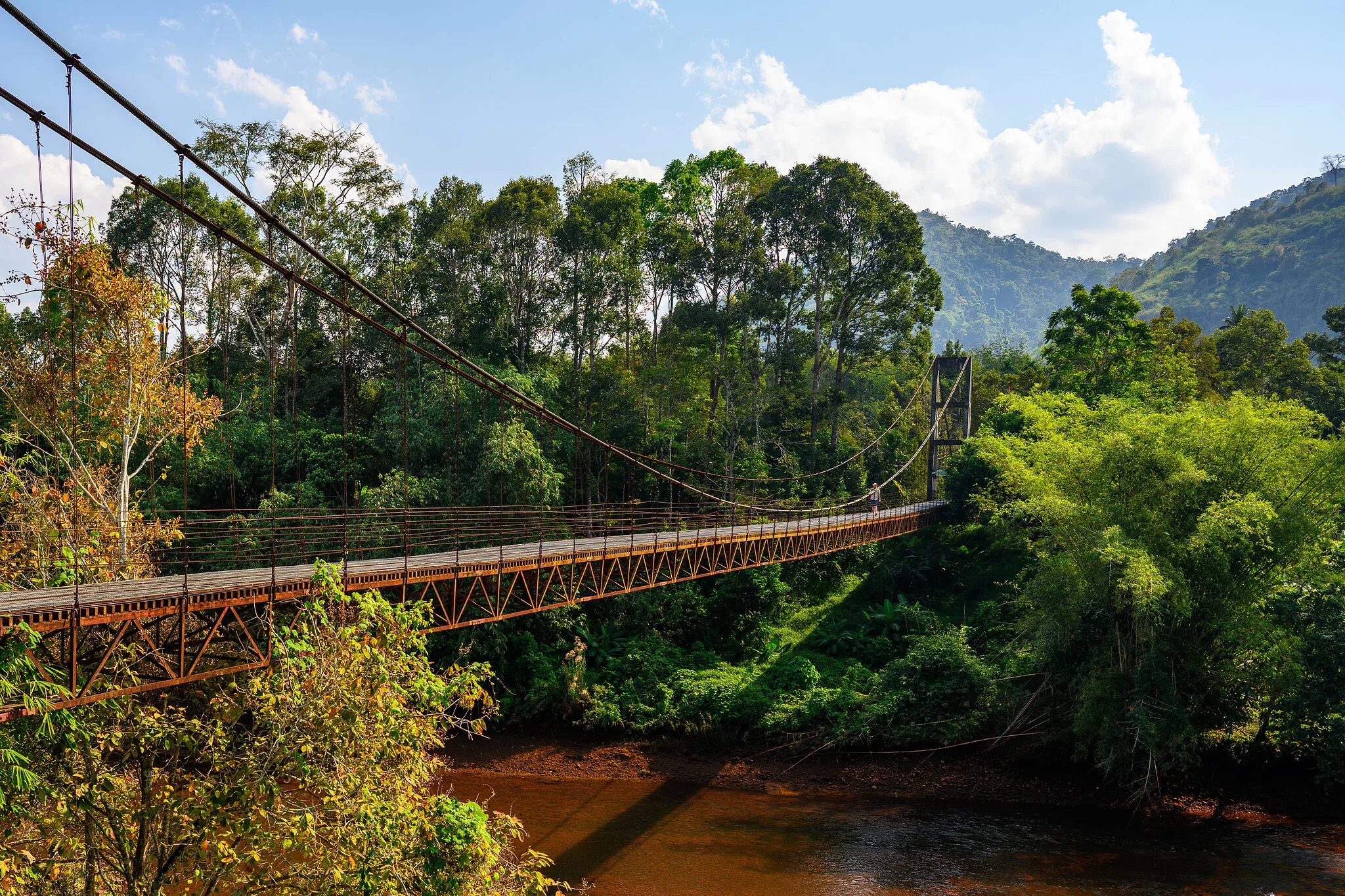 Suspension bridge spanning a jungle river near Cheow Lan Lake, Khao Sok