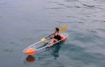 Guests paddling a clear kayak in Phang Nga Bay