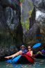 Boat passing through a narrow limestone cave passage