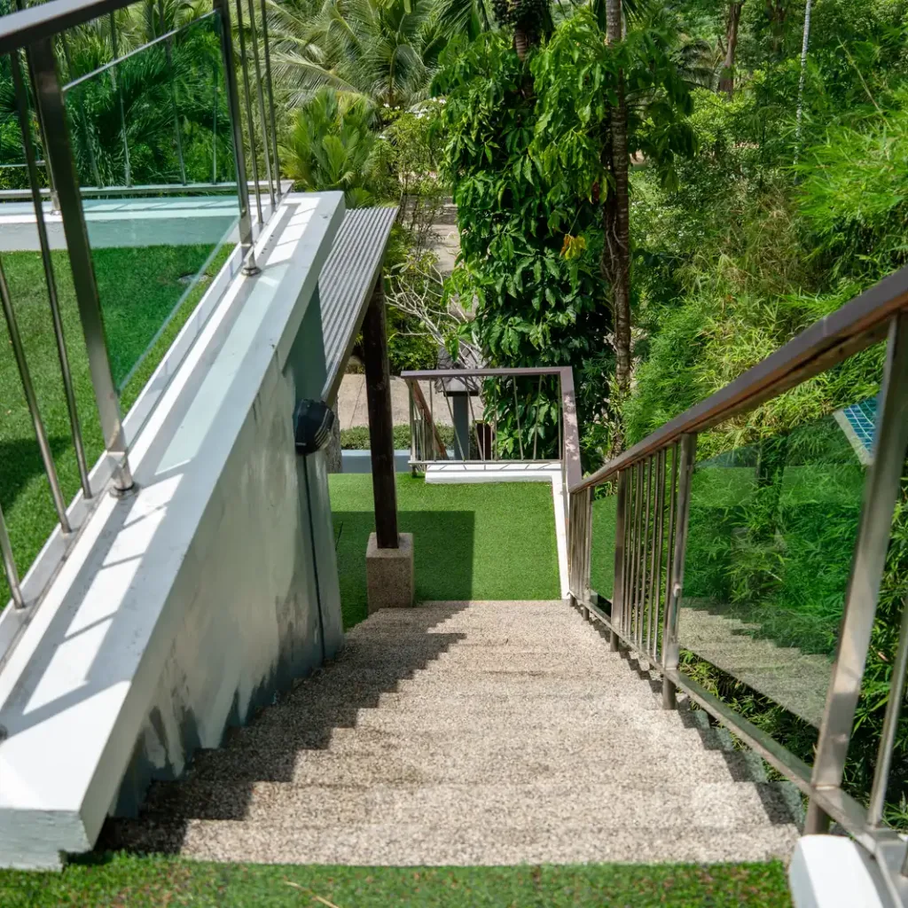 Garden staircase with stainless railings down the slope