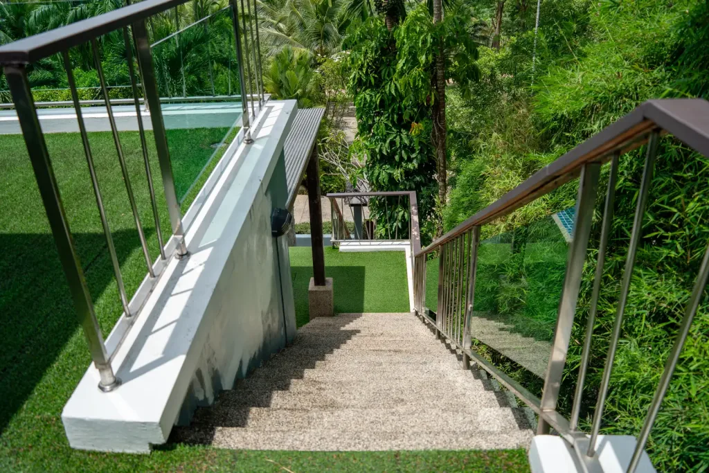 Garden staircase with stainless railings down the slope