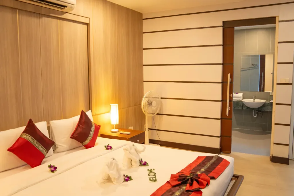 King bedroom with warm lighting and ensuite