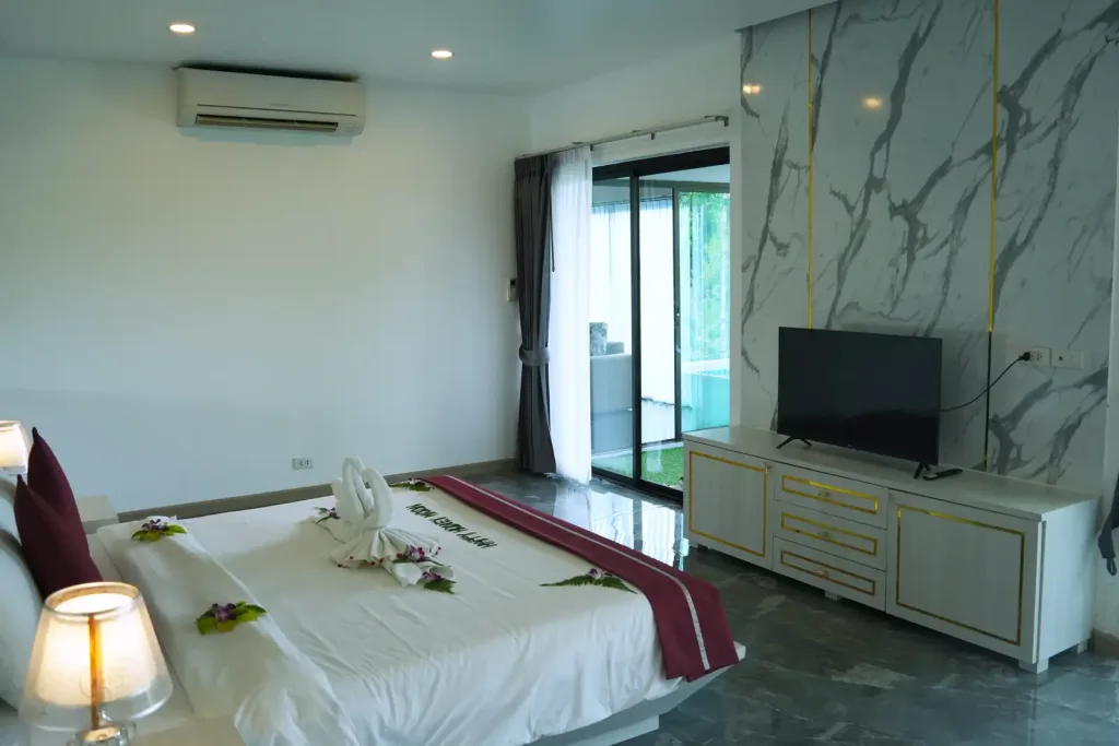 Bedroom with marble wall, TV and garden access
