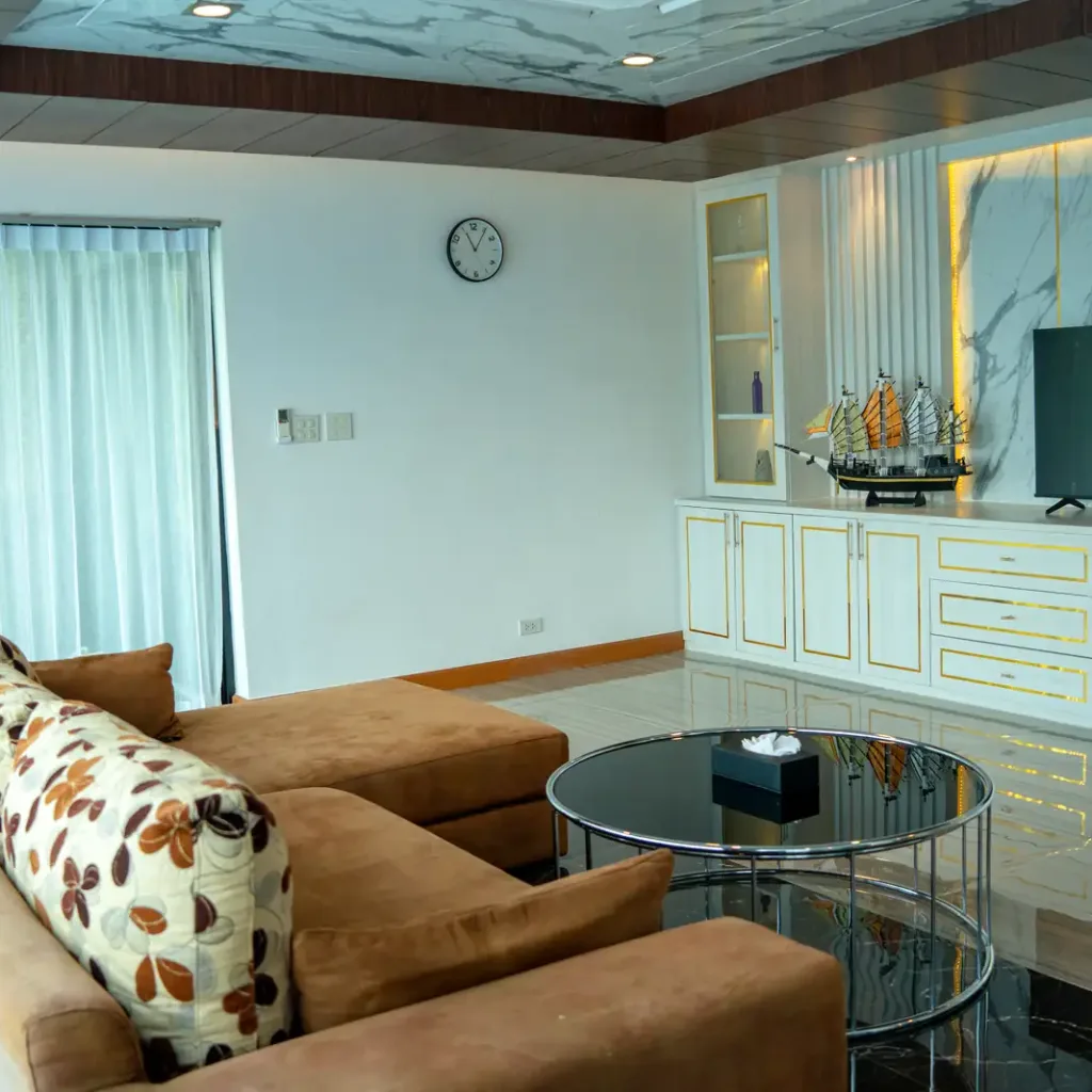 Living room with sofa, glass table and TV