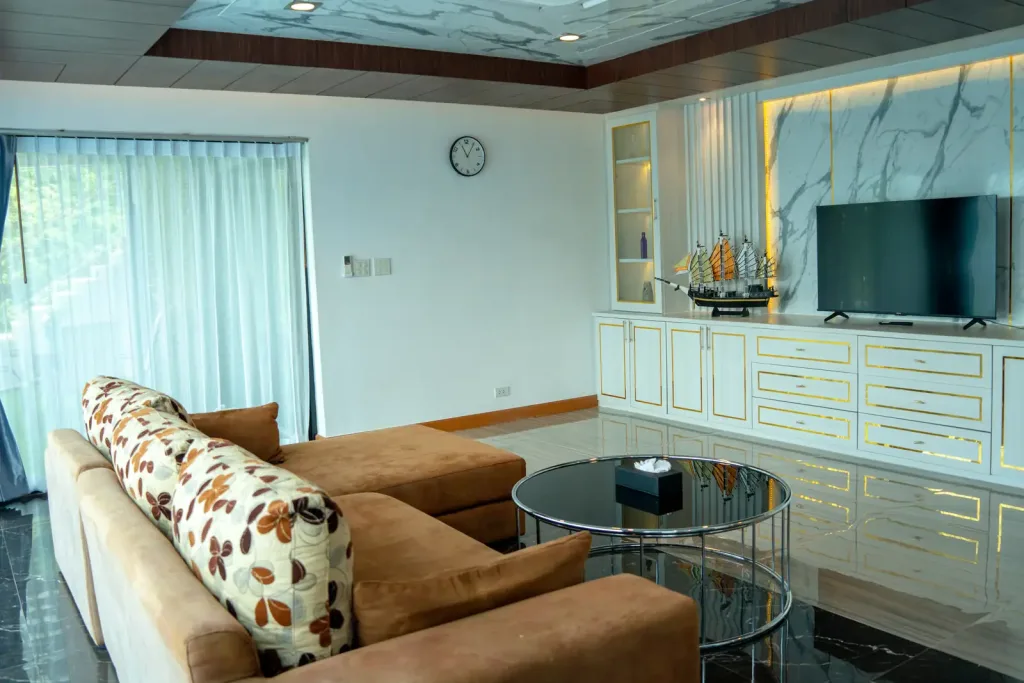 Living room with sofa, glass table and TV