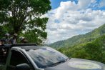 Guests ride the open 4x4 truck to a high rainforest viewpoint on the exclusive Khao Lak off-road safari