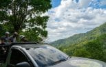 Guests ride the open 4x4 truck to a high rainforest viewpoint on the exclusive Khao Lak off-road safari