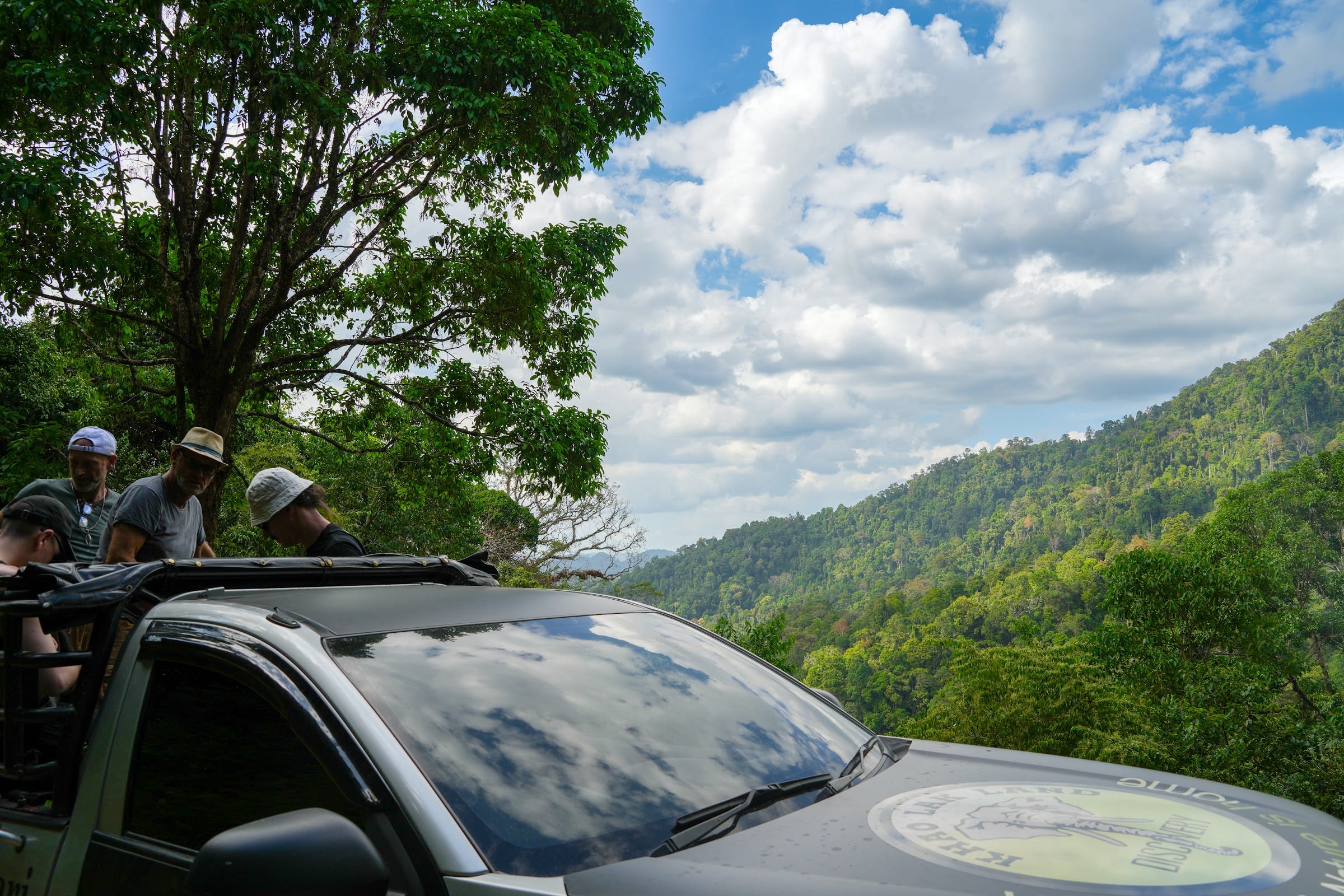 Guests ride the open 4x4 truck to a high rainforest viewpoint on the exclusive Khao Lak off-road safari