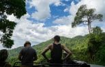Guests stand in the open truck bed taking in a panorama of forested mountains on the Khao Lak off-road safari