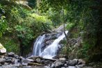 A secluded waterfall tumbles over mossy rocks deep in the rainforest visited on the Khao Lak off-road safari