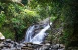 A secluded waterfall tumbles over mossy rocks deep in the rainforest visited on the Khao Lak off-road safari
