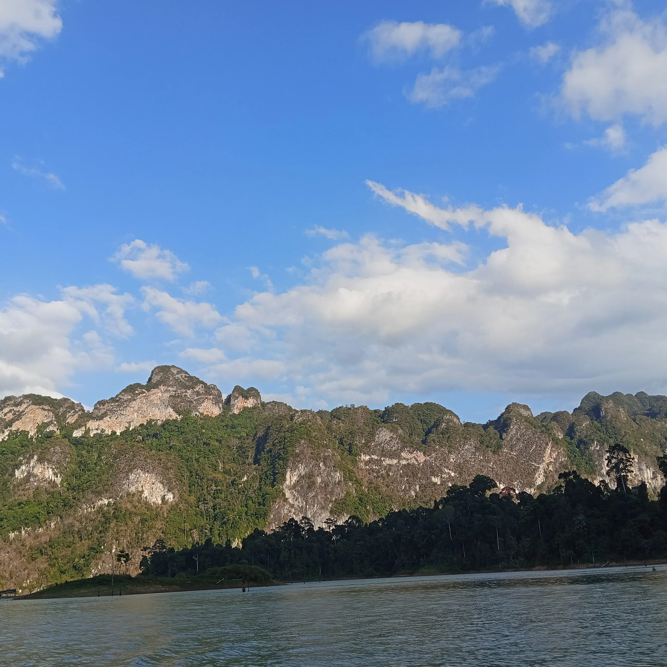 A long jungle-covered limestone ridge stretching across the horizon above Cheow Lan Lake in Khao Sok National Park