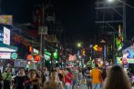 Crowds fill Bangla Road beneath a wall of neon signs on a Patong nightlife evening in Phuket