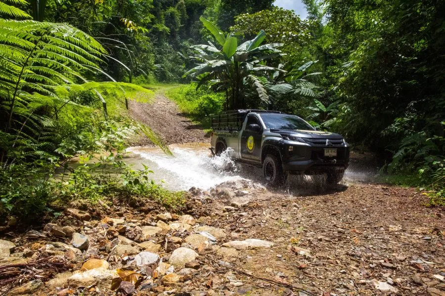 KLLD 4x4 off-road truck crossing a jungle stream on the Khao Lak Expedition
