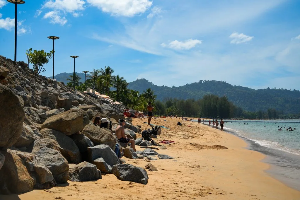 Golden Sand And Granite Boulders On Bang Niang Beach, Khao Lak, With Forested Hills Behind